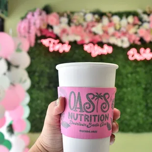  a hand holding a cup of coffee