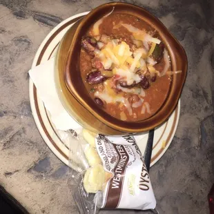 a bowl of chili and cheese soup