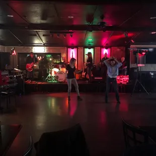 two people dancing in a dimly lit room