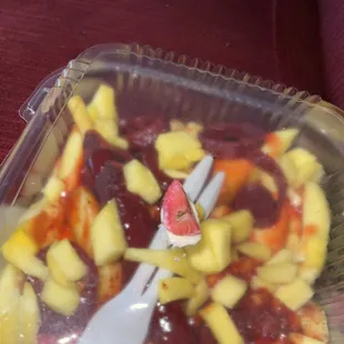 a plastic container filled with fruit