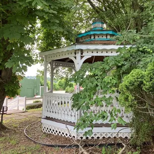 a gazebo surrounded by trees
