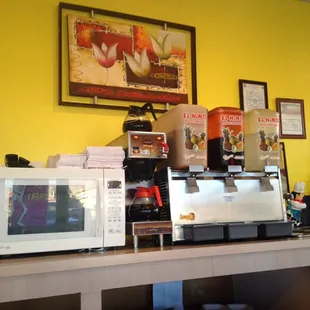 a coffee machine and microwaves on a counter