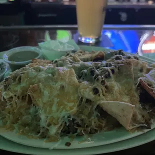 a plate of nachos and a glass of beer