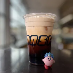 a cup of iced coffee and a toy