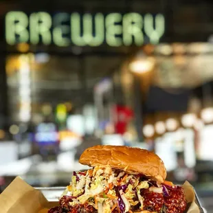 a hand holding a tray of food