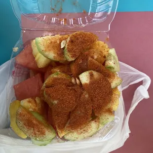 a plastic container filled with fruit