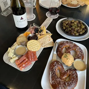 Meat and cheese board (2+2), pan roasted olives, and soft pretzels with cheese and mustard.