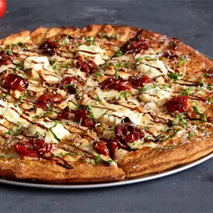 a whole pizza on a plate