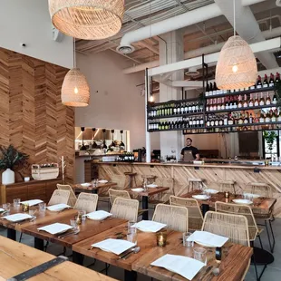 the interior of a restaurant with tables and chairs