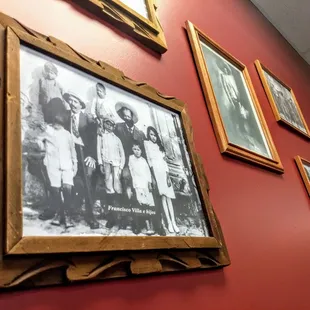 Framed photographs decorate the wall