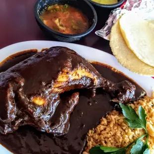 Pollo en mole negro, yellow rice, fresh house-made tortillas