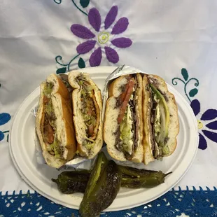 two sandwiches on a plate with pickles