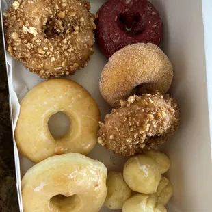 Two glazed, two crumb cake, cinnamon sugar, red velvet and donut holes