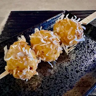 Cascaron. Ground glutinous rice donuts covered w a coconut caramel glaze and shredded coconut.