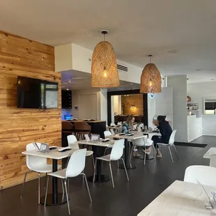 a dining area with tables and chairs