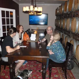 club members enjoying a glass of wine in our barrel room