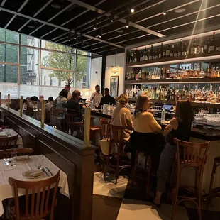 people sitting at a bar in a restaurant