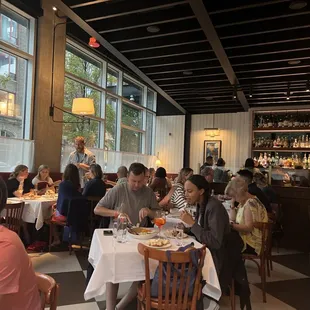 a large group of people eating in a restaurant