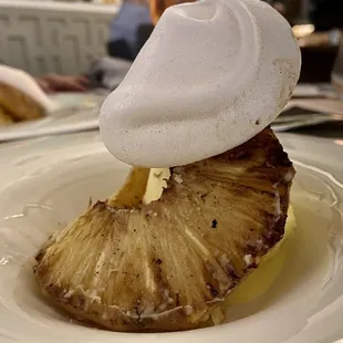 a pineapple with whipped cream on top
