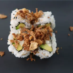 a sushi roll on a black plate