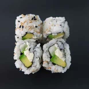 a sushi roll with avocado and sesame seeds