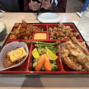 Sweet and spicy and teriyaki chicken bento with calamari and veggies
