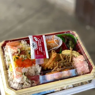 a person holding a box of food
