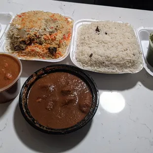 (left to right then bottom) yogurt, chicken biryani, rice, saag paneer, chicken vindaloo and lamb Rogan josh