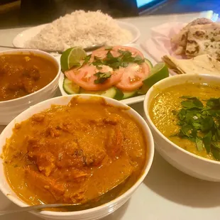 Lamb Vindaloo (left), Butter Chicken (middle), dal Daal Tadka (right), kachumber (center) with garlic naan