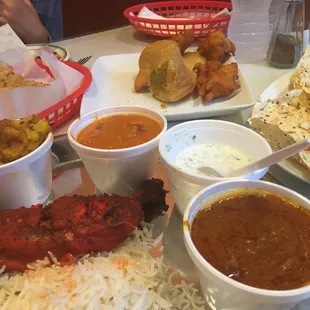 Our own mini buffet here showing the remainder (we ate half already) of the veggie appetizer sampler, masala papad, and non-veg thali.