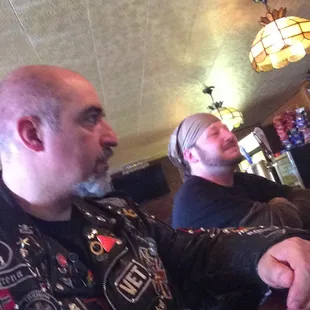 two men sitting at a bar