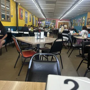 people sitting at tables and eating