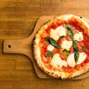 a pizza on a wooden board