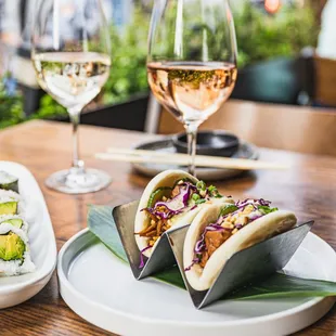 a plate of sushi and a glass of wine