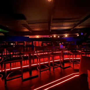 a dimly lit bar with red lights