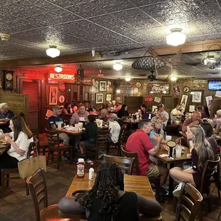 a large group of people sitting at tables in a restaurant