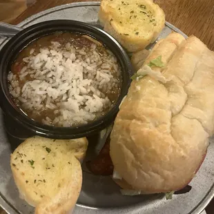 Cup of chicken and sausage gumbo. Garlic bread. Po-boy.
