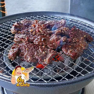 a barbecue grill with meat on it
