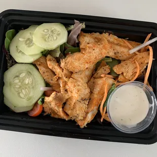 a chicken salad with cucumbers and dressing