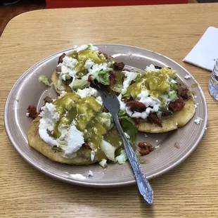 Sopes al pastor with cotija and salsa verde.