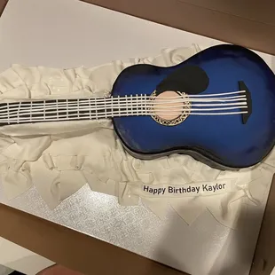 a guitar cake in a box