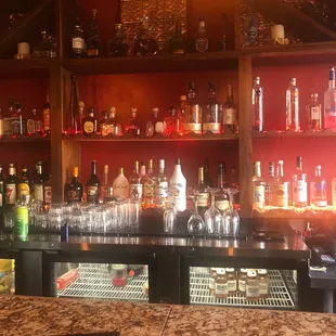 a bar with a lot of bottles of alcohol