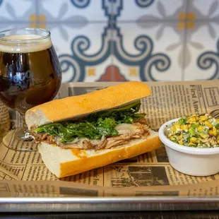 a sandwich and a side of corn salad