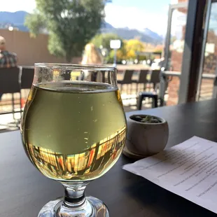 a glass of white wine on a table