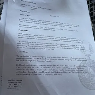 a table with a menu and wine glasses