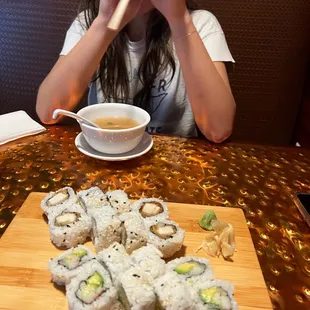 a woman eating sushi with chopsticks
