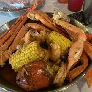 Seafood boil corn potatoes sausage crab legs lobster tails