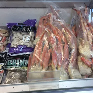 a variety of seafood in a display case