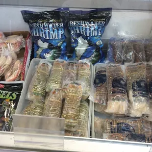 various types of seafood in a display case