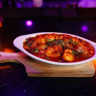 a dish of shrimp in tomato sauce